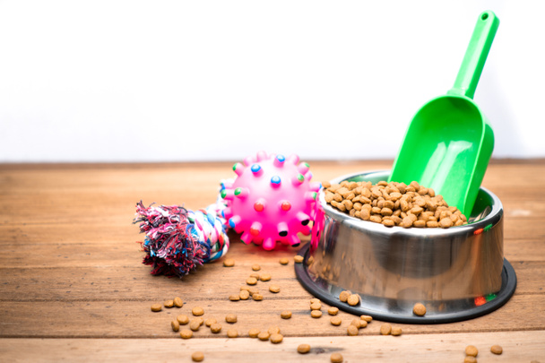 Pet food with accessories on wooden table.  Dry food for dog  - Photo, Image
