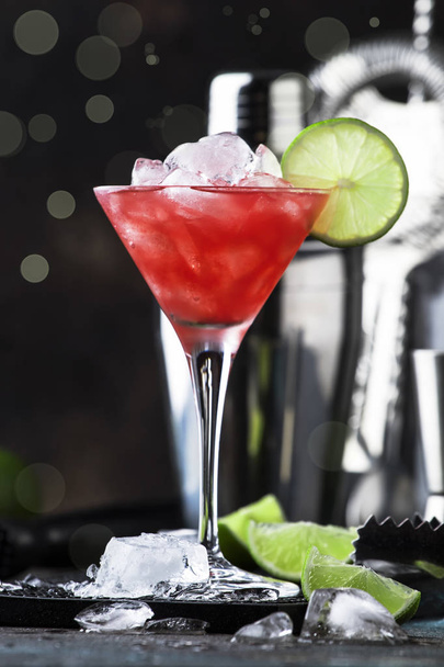 Watermelon cobler, alcoholic cocktail with vodka, lemon juice, mint, lime and crushed ice, metal bar tools, dark background - Photo, Image