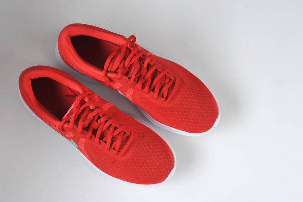 Red sneakers on a white background. View from above. Free space to place text. - Foto, afbeelding