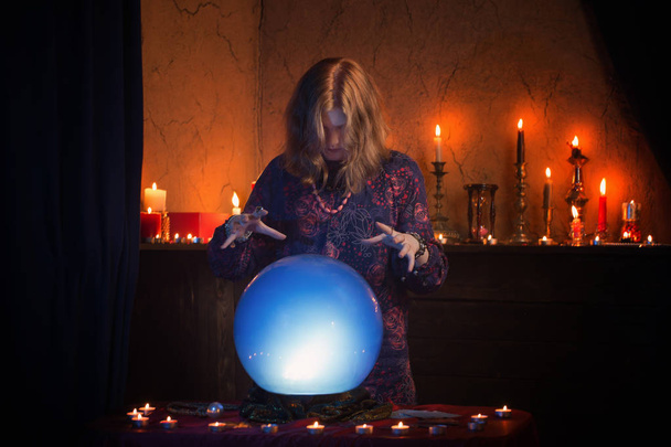 woman fortune teller with illuminated crystal ball - Fotoğraf, Görsel