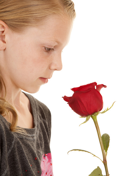 girl look down at rose close - Foto, imagen