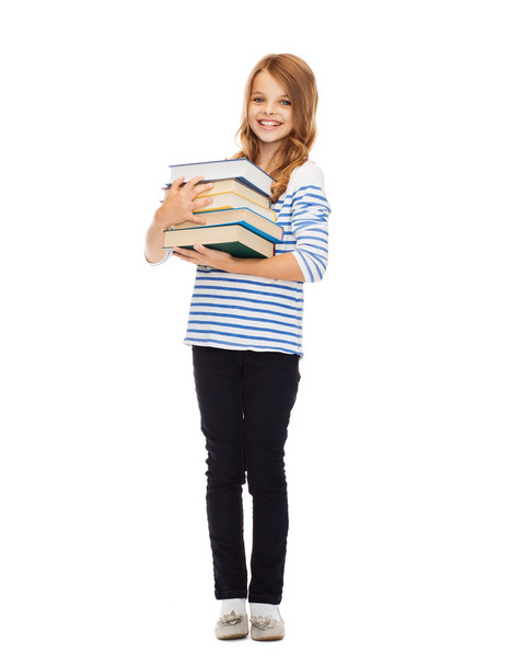 Little student girl with many books - 写真・画像