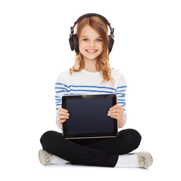 Child with headphones showing tablet pc - Fotó, kép
