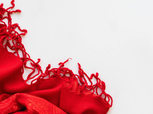 Bright red scarf on white background. Folded warm accessory with copy space. - Foto, Imagem