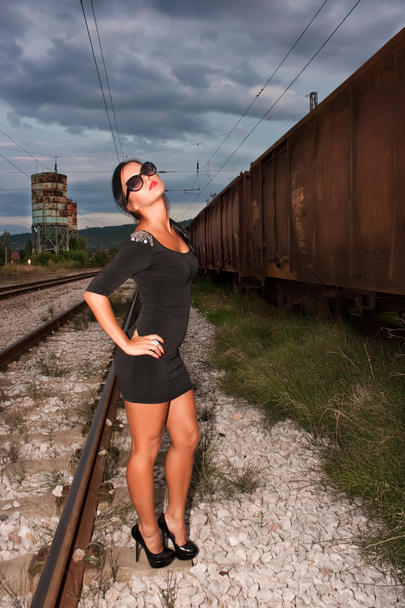 Woman on railway tracks - Фото, изображение