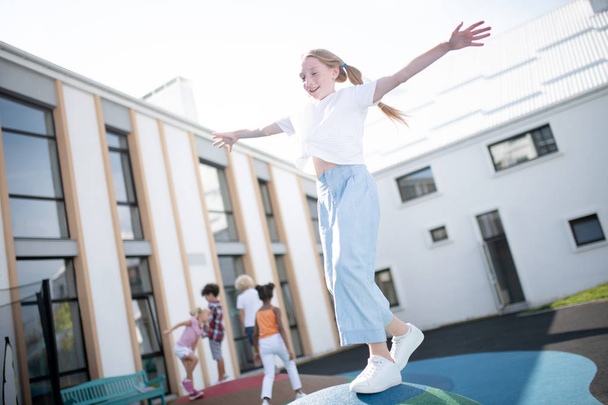 Girl wearing white sneakers having fun outside on nice sunny day - Foto, Imagem