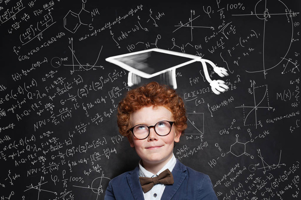 Successful kid schoolboy in graduation hat on science background - Photo, Image