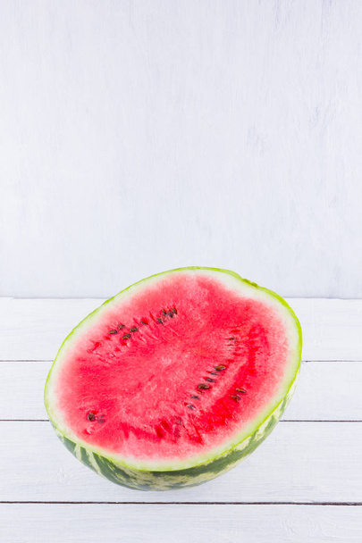 Half of watermelon on white background. Sliced watermelon on wooden boards. Healthy food for vegan. Top view - Foto, imagen