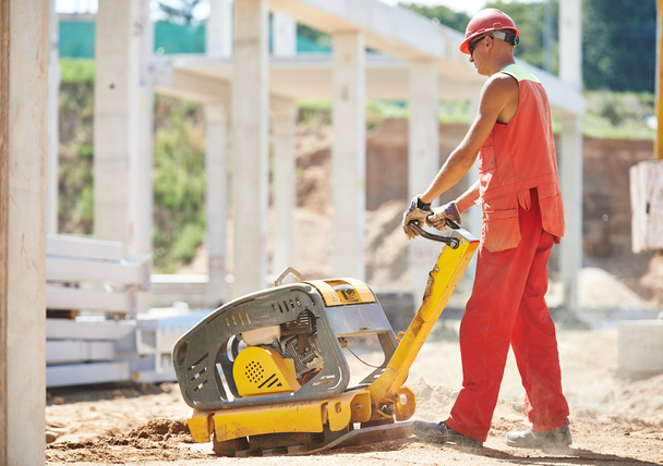 Worker with compaction machine - Foto, Imagem