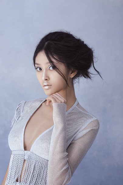 Futuristic sexy young asian woman. - 写真・画像