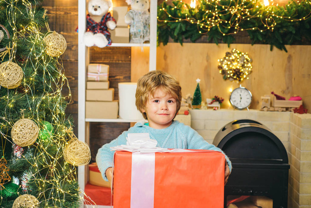 Cute little kids celebrating Christmas. Christmas Celebration holiday. Happy cute child in Santa hat with present have a Christmas. Little Santa Claus gifting gift. - Фото, зображення