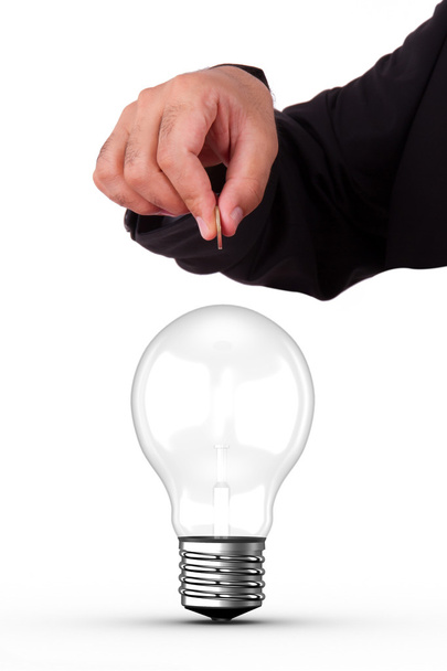 Businessman Holding Coin and Light Bulb - Фото, изображение