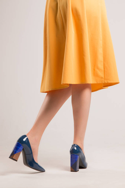 Girl in blue shoes with high heels. View from the back. - Photo, Image