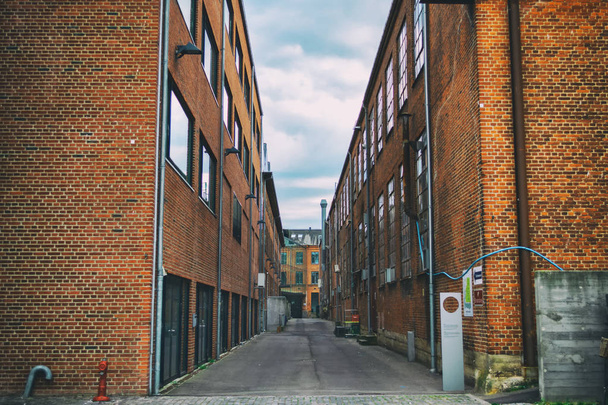 Old red brick industrial buildings. Toned photo. Architectural background. - Valokuva, kuva