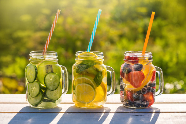 Mason jars of infused water with fruits - Fotó, kép