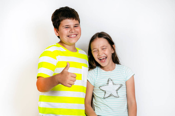 Boy and little girl showing their thumbs up - Photo, image