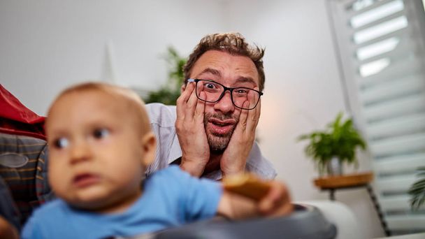 Single dad going nuts at home with a baby. - Fotografie, Obrázek