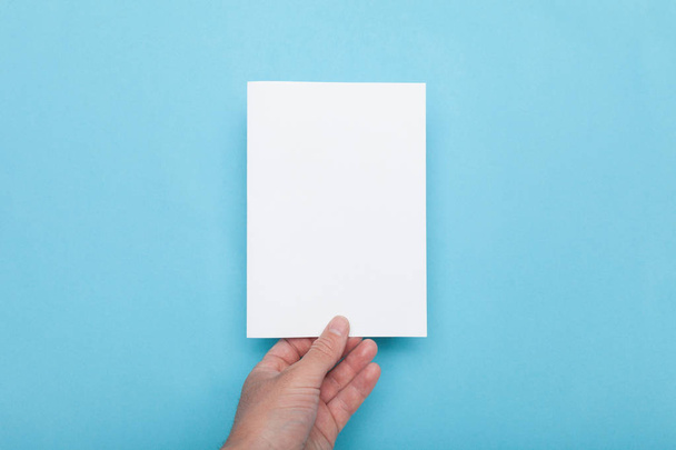 Paper flyer A5 mockup, man holding blank. - Фото, изображение