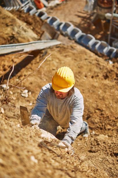 Construction worker on a heavy site doing hard work. - Fotoğraf, Görsel