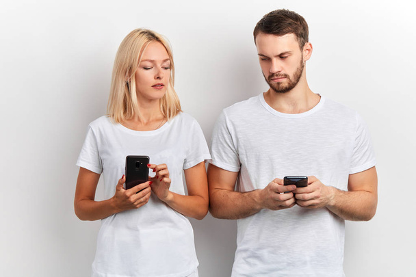 two attractive people comparing their smart phones - Foto, afbeelding