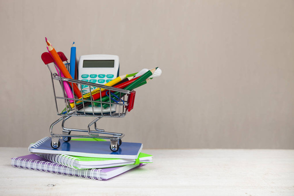 Items for school in a shopping cart. - Foto, Imagem