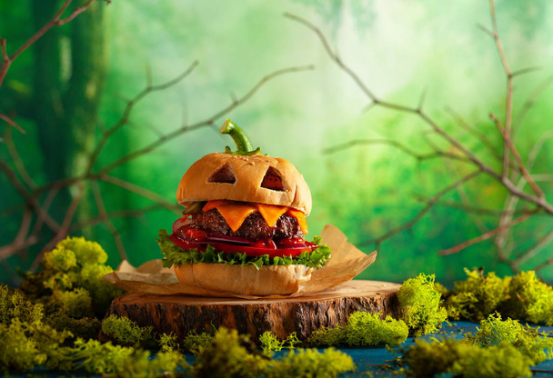 Halloween party burger in shape of scary pumpkin  on  wooden boa - Foto, Imagem