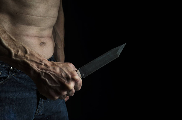 Man with a knife in his hand - Zdjęcie, obraz