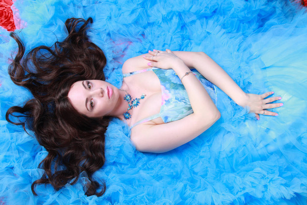 Portrait de jeune femme en robe longue bleue de soirée sur fond de studio
 - Photo, image