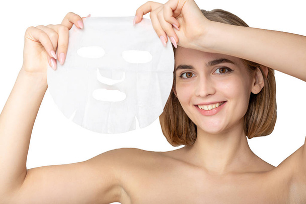 Cheerful girl with moisturizing with sheet mask  - Photo, image