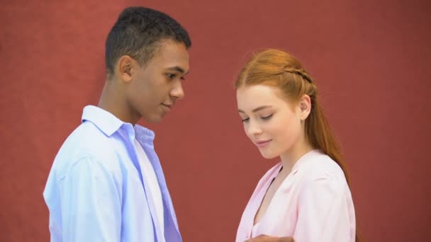 Smiling mixed-race boy tenderly touching shoulder and chin of his girl, love - Filmmaterial, Video