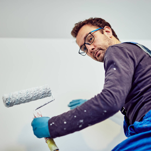 Paredes de pintura do trabalhador dentro da casa - consertos de renovação
. - Foto, Imagem