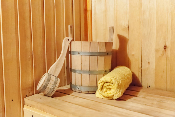 Interior details Finnish sauna steam room bathhouse with traditional sauna accessories basin scoop towel - Photo, Image