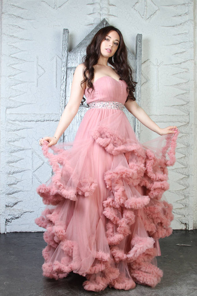 Portrait of fashionable young beauty girl in big long evening pink dress - Photo, Image