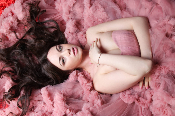 Portrait of fashionable young beauty girl in big long evening pink dress - Foto, imagen