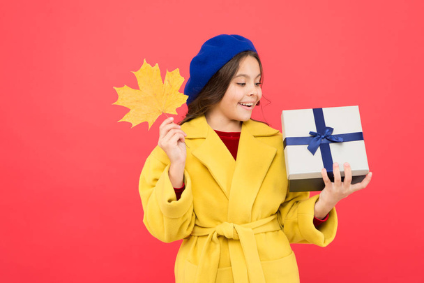 So beautiful. autumn kid fashion. happy small girl with maple leaf and present box. fall season. school shopping sales. girl child in french beret hold gift. Autumn weather change. thanksgiving day - Photo, Image