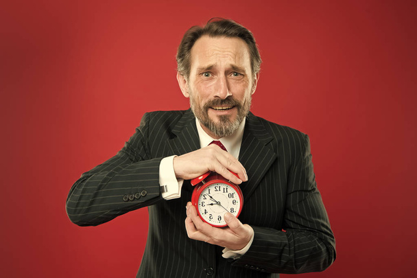 Time management skills. How much time left till deadline. Manager with alarm clock. Man bearded businessman hold clock. Mature man beard ready start working. Time to work. Businessman care about time - Zdjęcie, obraz