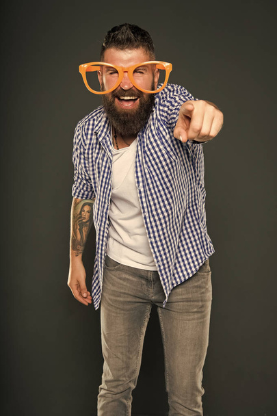 Are you going to the party. Party man pointing finger on grey background. Bearded man wearing party glasses. Preparing a cool party - Foto, immagini