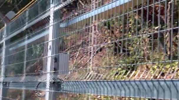 metal fences of the pedestrian passage in the prison - Felvétel, videó