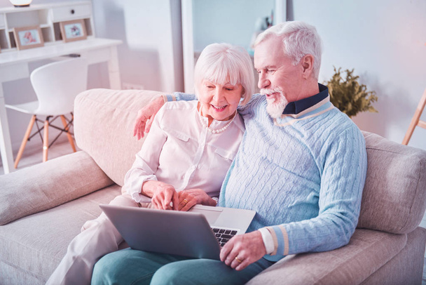 Modern beaming grandparents having video chat with their grandchildren - Foto, Imagem