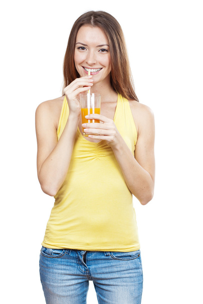 Beautiful brunette woman holding glass of juice - 写真・画像