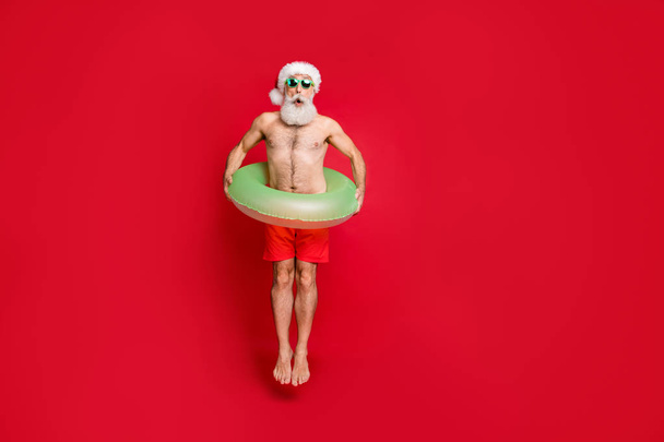 Full length body size view of nice attractive funky positive gray-haired man enjoying leisure having fun poolside pond water air fly isolated over bright vivid shine red background - Fotografie, Obrázek