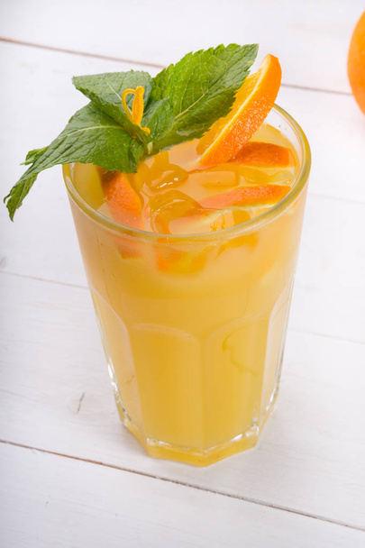 Glass of orange juice with ice cubes - 写真・画像