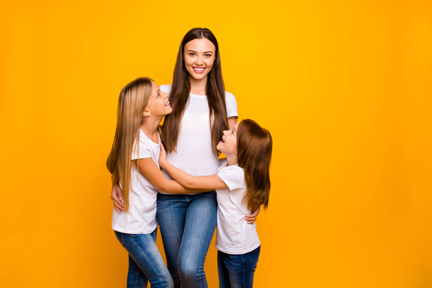 Photo of two little ladies with lovely babysitter wear casual outfit isolated yellow background - Fotografie, Obrázek