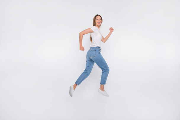 Full length body size photo of attractive nice cute girl running away from camera while isolated with white background - Foto, Imagem