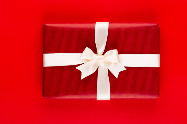 Christmas holiday present box on red background. - 写真・画像