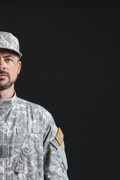 Soldier in camouflage on dark background - Photo, Image