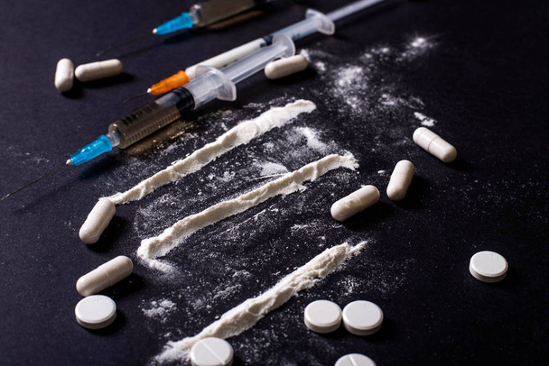Hard drugs on dark table. heroin, cocaine, amphetamine, ecstasy, pills and more. Creative idea. Drugs. Sad. Die. Illness - Photo, Image