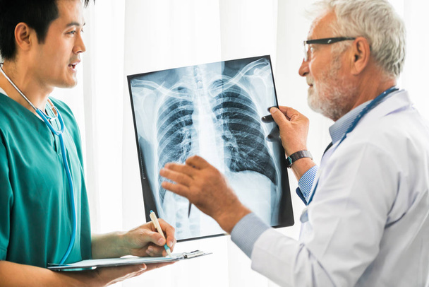 Doctors working with x ray film of patient chest. - Foto, imagen