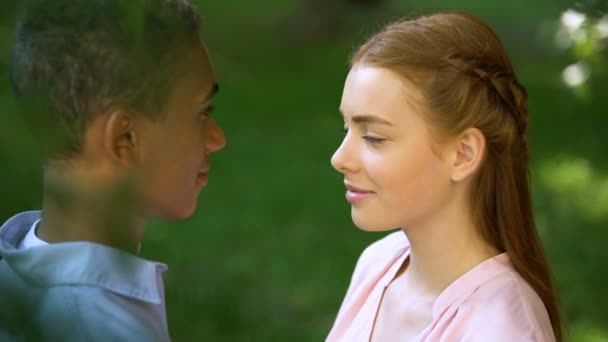 Підліток багаторасовий пара торкається чола в парку, довірчі відносини, любов
 - Кадри, відео