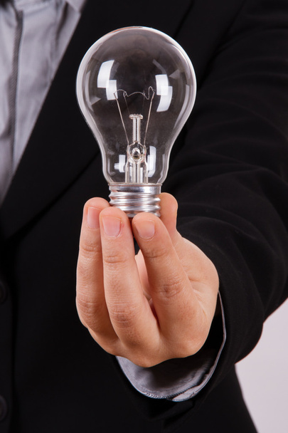 Business Woman Holds Lightbulb - Foto, Bild